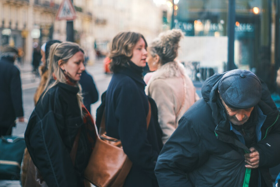 Diverse group of friends talking and laughing on a city sidewalk