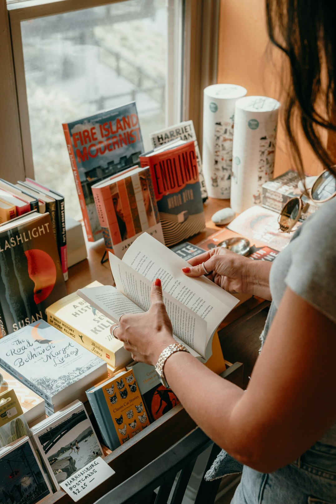 Person reading and taking notes at a library table